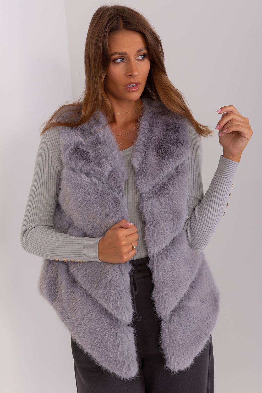 Versatile luxury women's gilet by AT, highlighting the practicality of pockets and elegant design for cooler days.