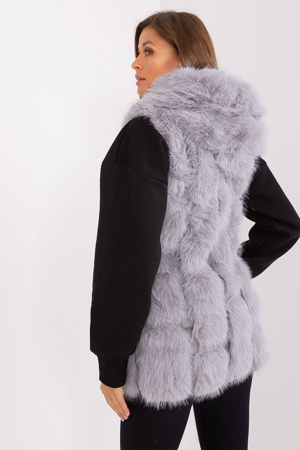 Stylishly worn Elegant Women's Fur Vest with Hood by AT, perfect for adding elegance to any outfit in colder weather.