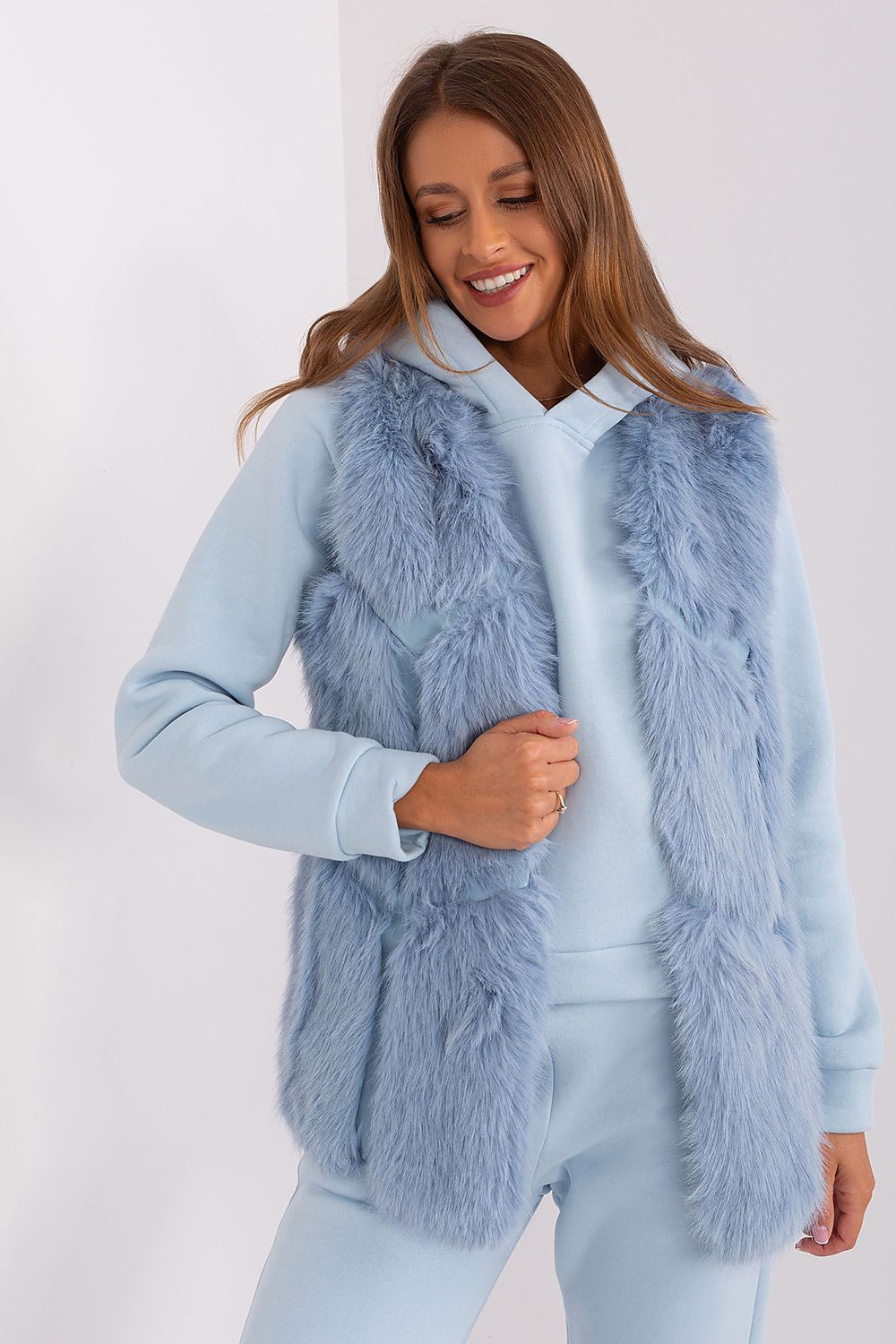 Luxurious polyester fur vest from AT with practical pockets, perfect for layering on chic outfits for spring and fall.