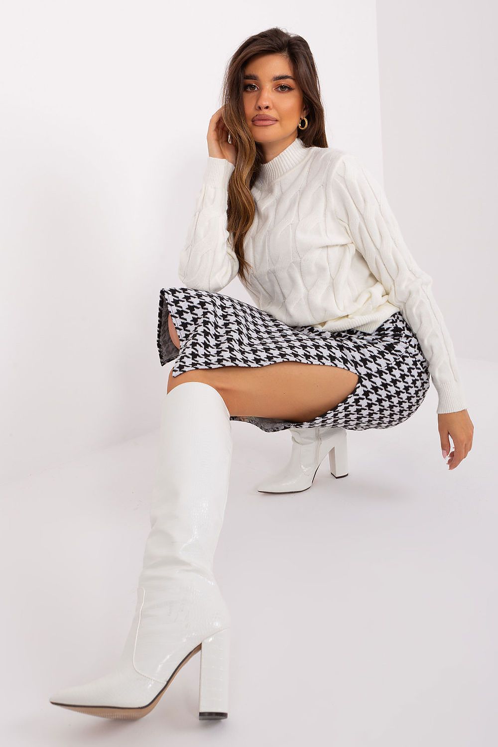 Elegant midi knit skirt by Lakerta featuring a charming peplum design, made from a comfortable cotton and spandex blend.