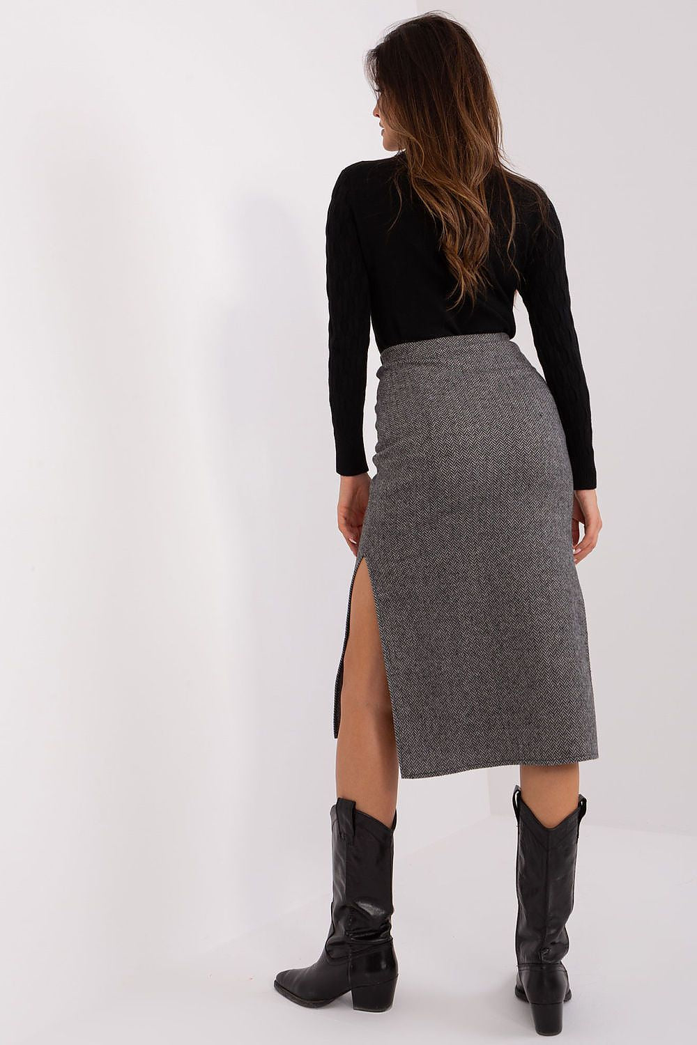 Back view of elegant midi knit skirt by Lakerta, designed with a flattering peplum and ideal for various occasions.