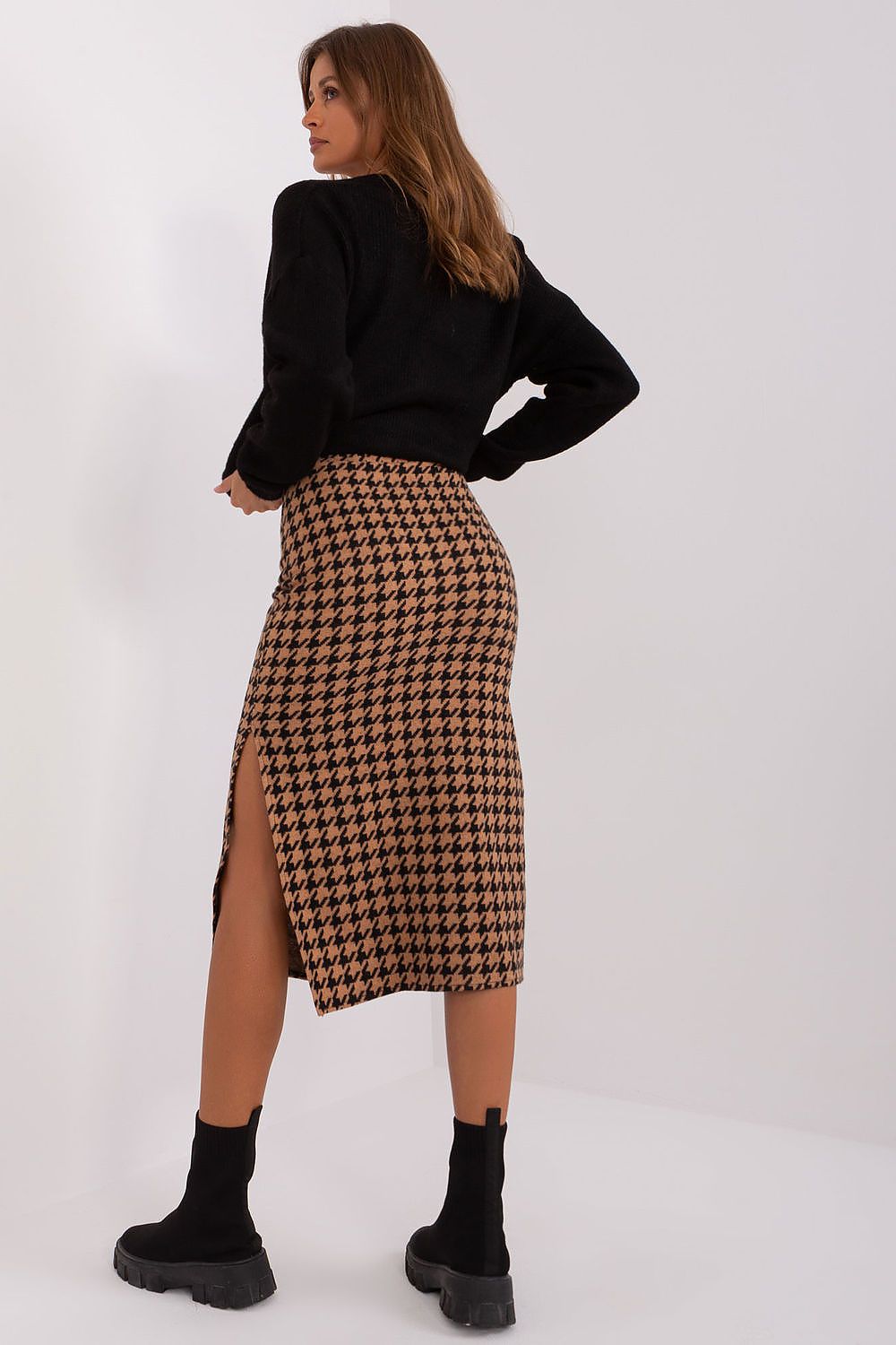 Model wearing the chic midi knit skirt by Lakerta in a fashionable setting, highlighting the elegance and versatility for various occasions.