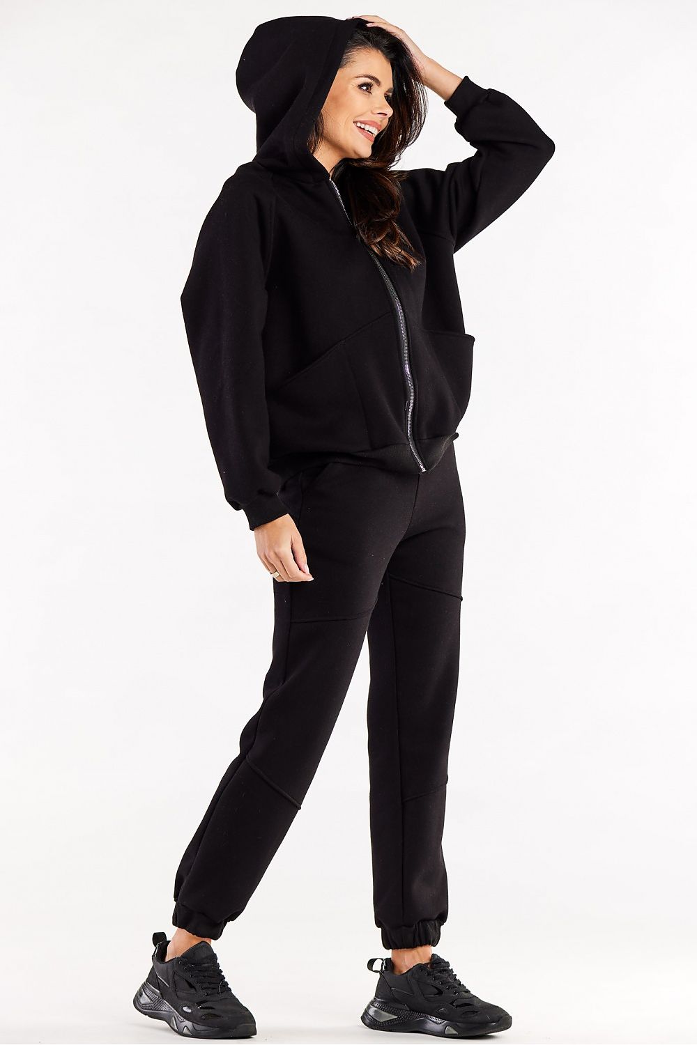 Lifestyle image of the Luxury Infinite You Hooded Zippered Sweatshirt featuring decorative elements and spacious pockets.