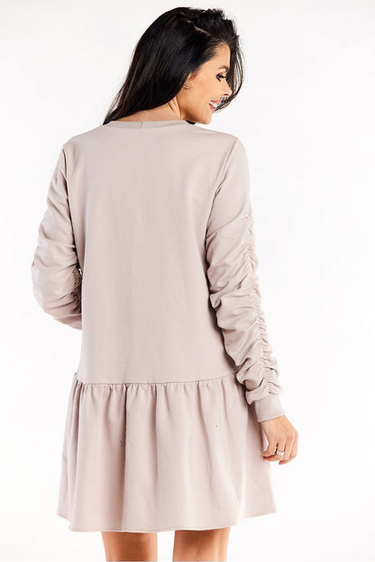 Model wearing the Luxurious Loose Cotton Dress with Ruffled Hem and Decorative Creased Sleeves by Infinite You, illustrating its stylish fit and graceful movement.