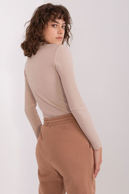 High-quality cotton blouse by BFG, elegantly designed with long sleeves and half turtleneck for a chic layering option.