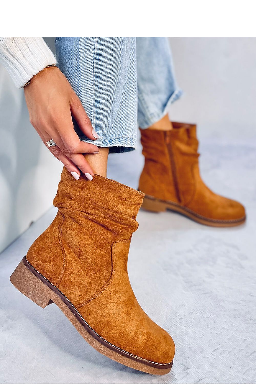 Close-up of luxurious Inello women's eco-suede boots featuring a convenient side zipper and plush fur lining for ultimate comfort and style.