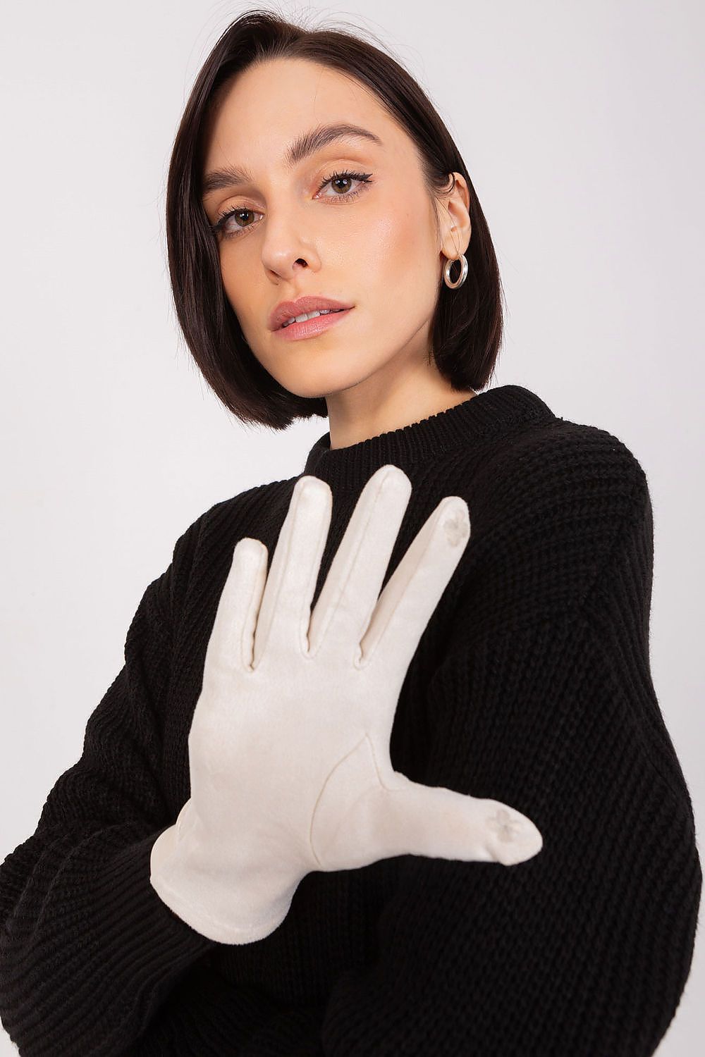 Woman wearing elegant touch screen gloves by AT, beautifully designed with embroidered flowers, perfect for fashionable functionality.