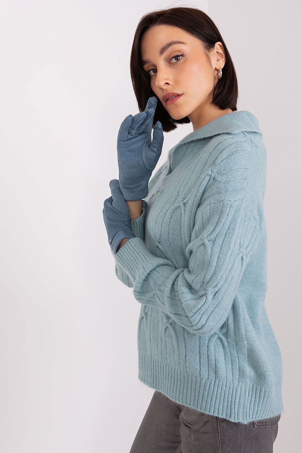 Flat lay of elegant touch screen gloves by AT, featuring a delicate embroidered flower design, ideal for stylish cold weather.