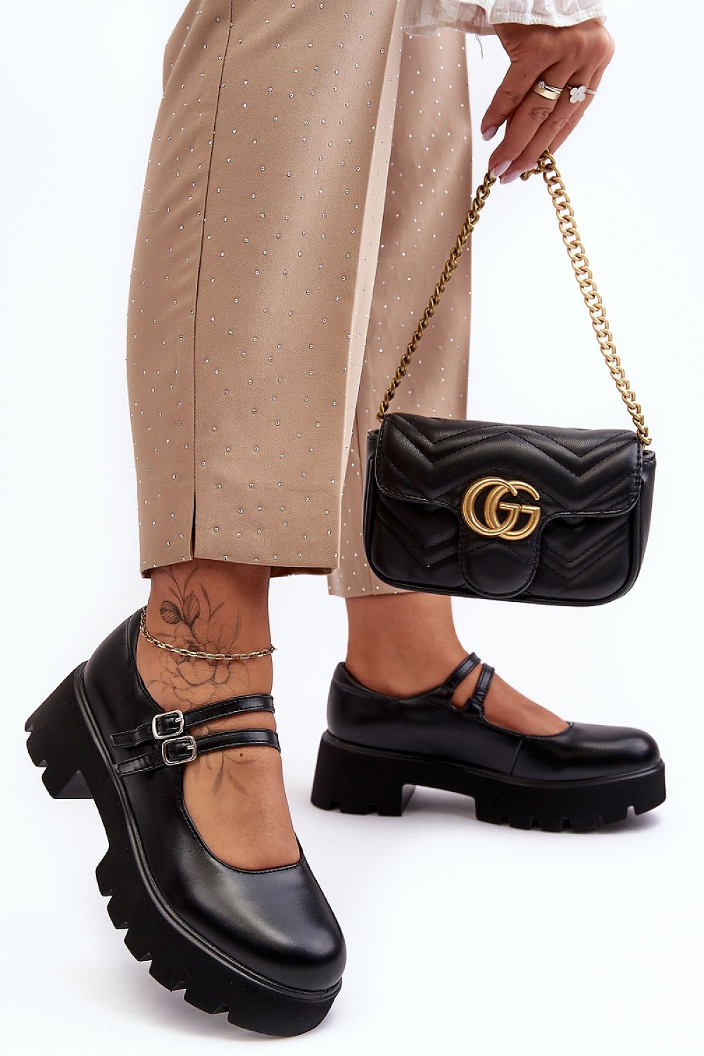 Stylish eco leather low shoes by Step in Style, showcasing a striking buckle detail paired with luxurious chic trousers and a designer handbag, embodying contemporary elegance.