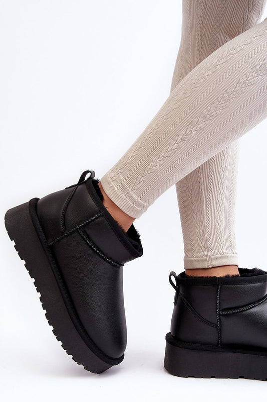 Close-up of Step in Style luxury women's snow boots showcasing the rich natural leather texture and plush fur lining, perfect for cold weather fashion.