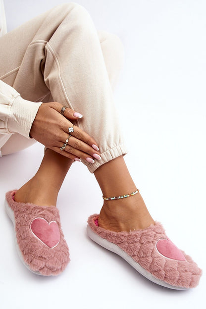 Stylish luxury INBLU pink slippers worn casually, featuring a plush heart motif, perfect for sensitive feet, by Step in Style.