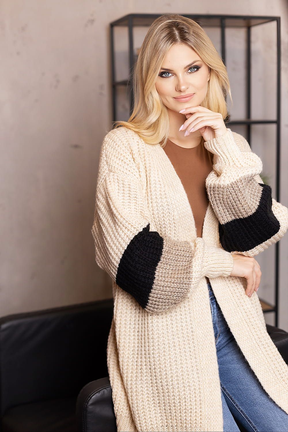 PeeKaBoo chic cardigan layered over stylish attire, enhancing a sophisticated wardrobe.