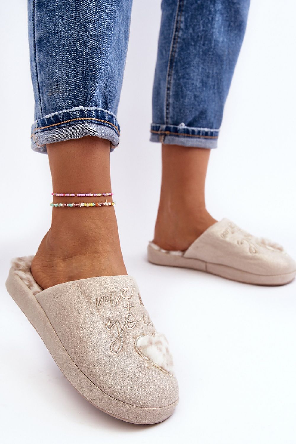 Elegant women's slip-on slippers from Step in Style, adorned with beautiful heart detail and plush fur lining for warmth.