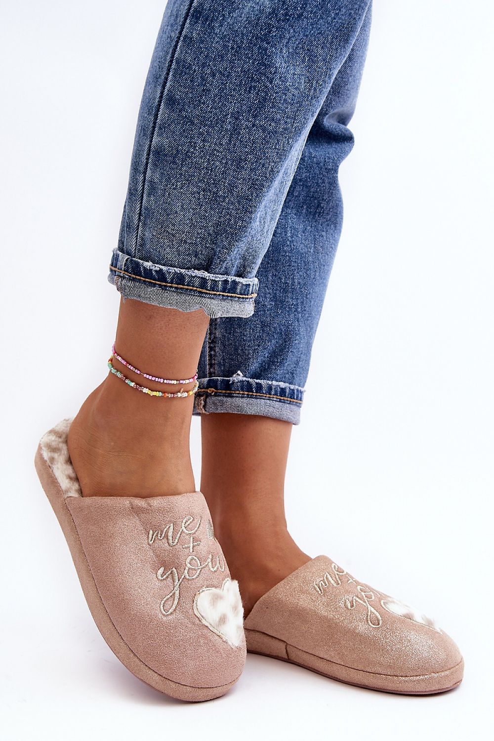 Stylish women's slip-on slippers from Step in Style, showcasing a heart motif and a luxurious fur-insulated footbed for extra comfort.