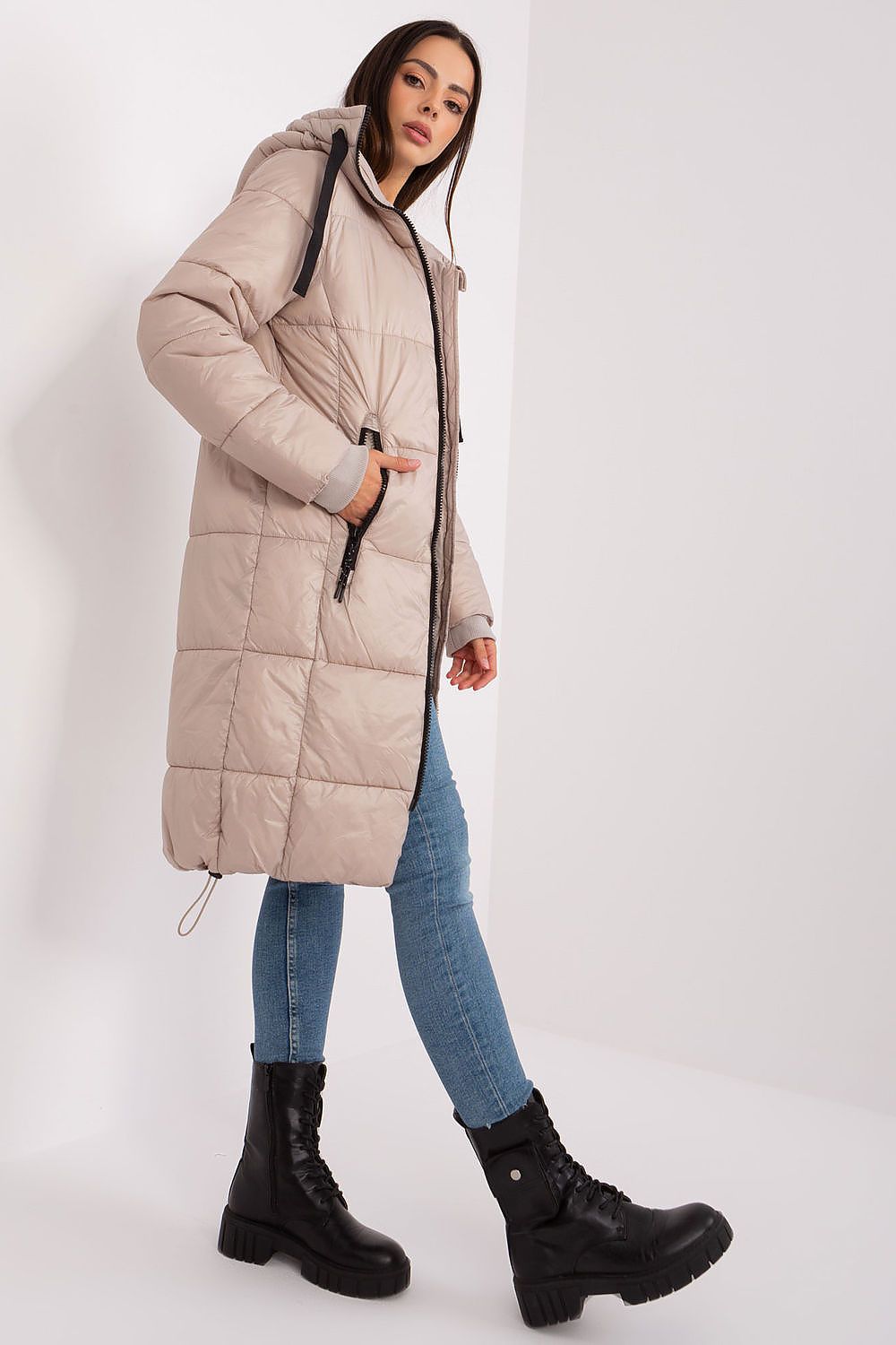 Elegant quilted women's jacket with hood by Sublevel, crafted from durable polyamide for warmth and comfort, featuring zippered pockets and stylish long cut, perfect for autumn and winter wear.