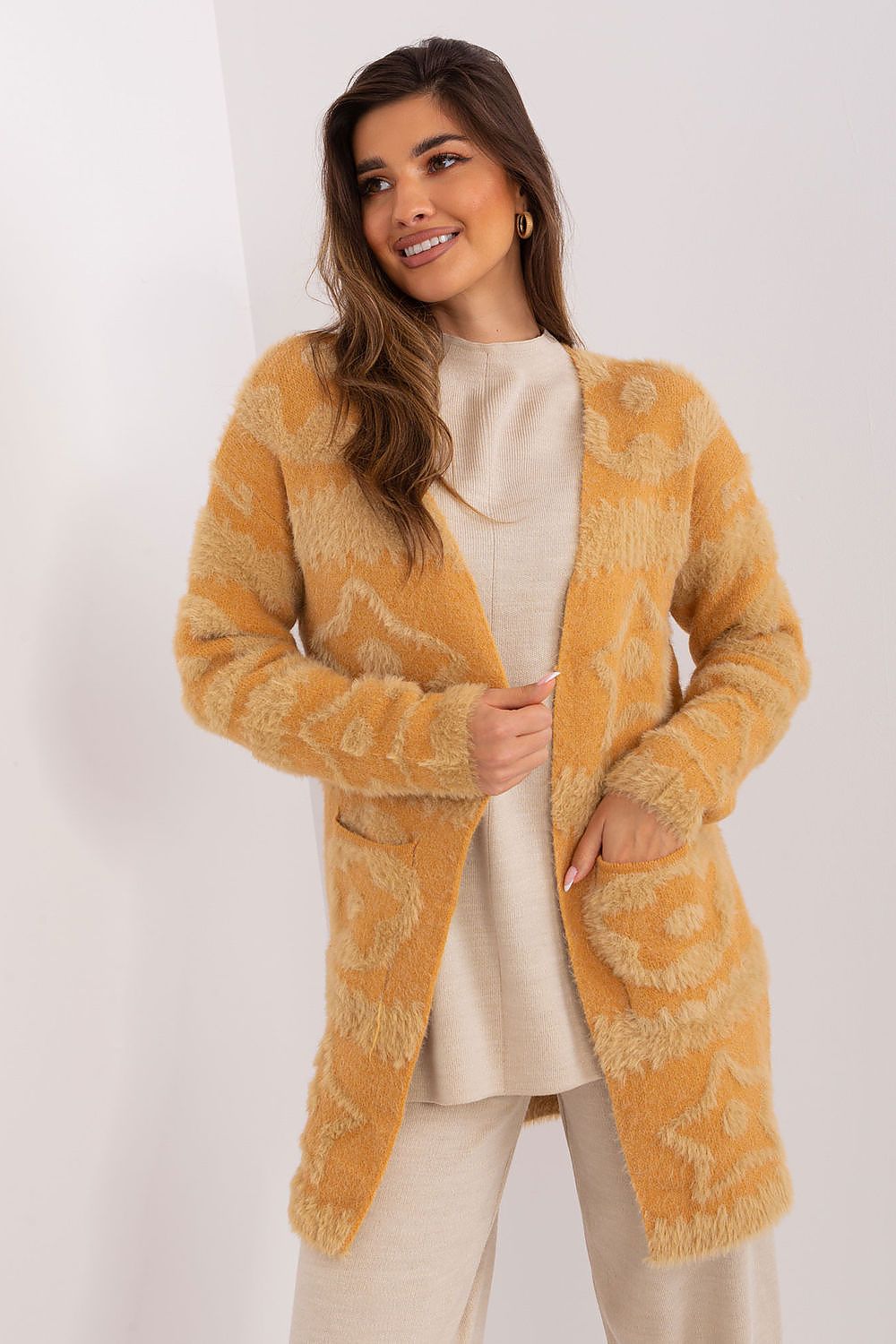 Comfortable long sleeve cardigan by AT with unique fabric textures, perfect for layering in cooler weather.