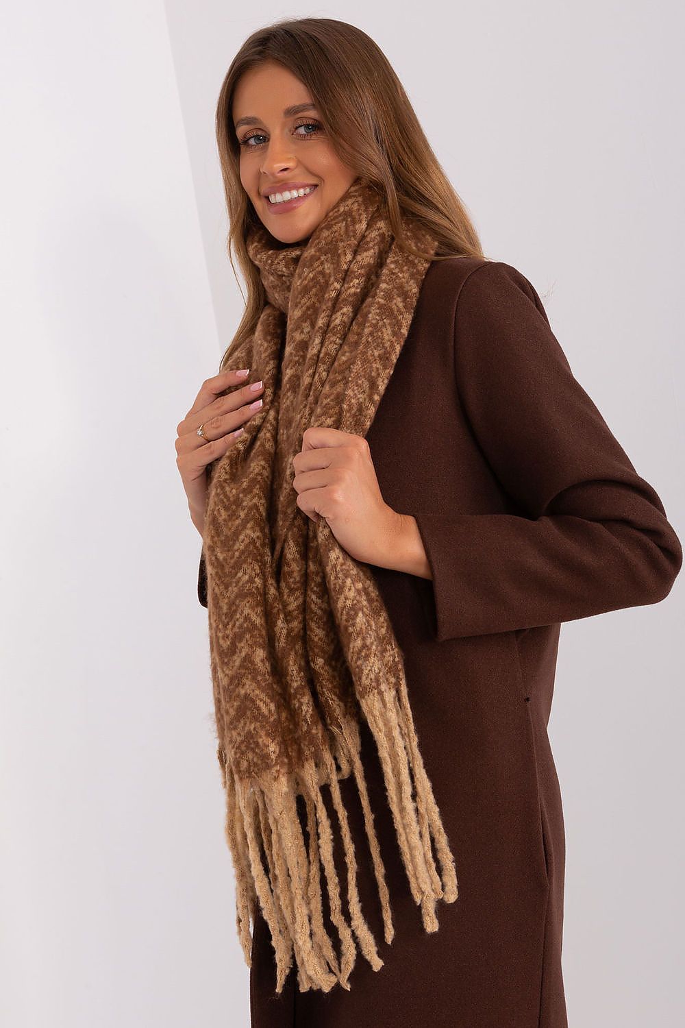AT exquisite long scarf with a geometric pattern, elevating elegance in winter fashion.