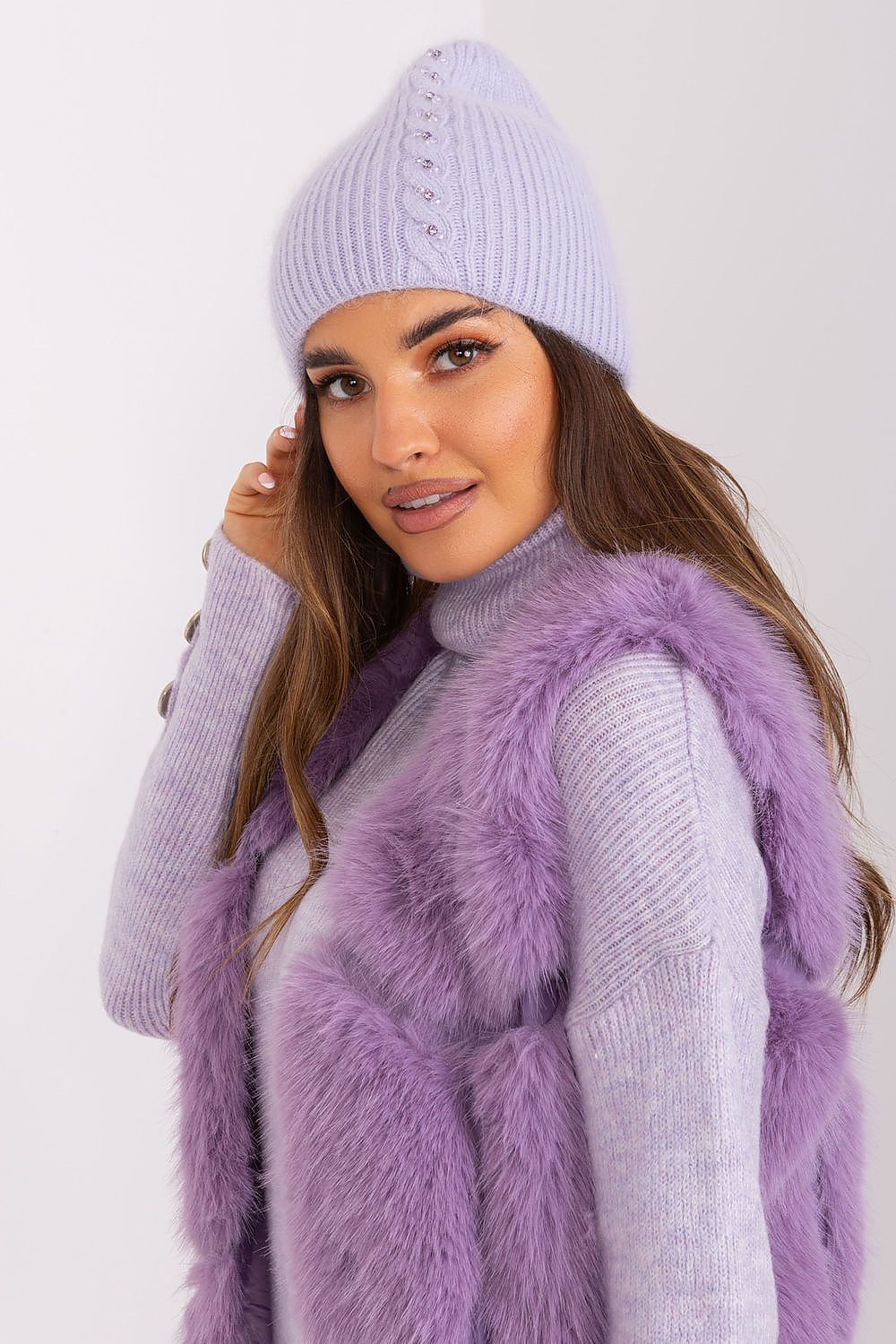 Luxurious winter warm hat by AT featuring a unique front application and elegant braided design, crafted from a comfortable acrylic and angora mix.