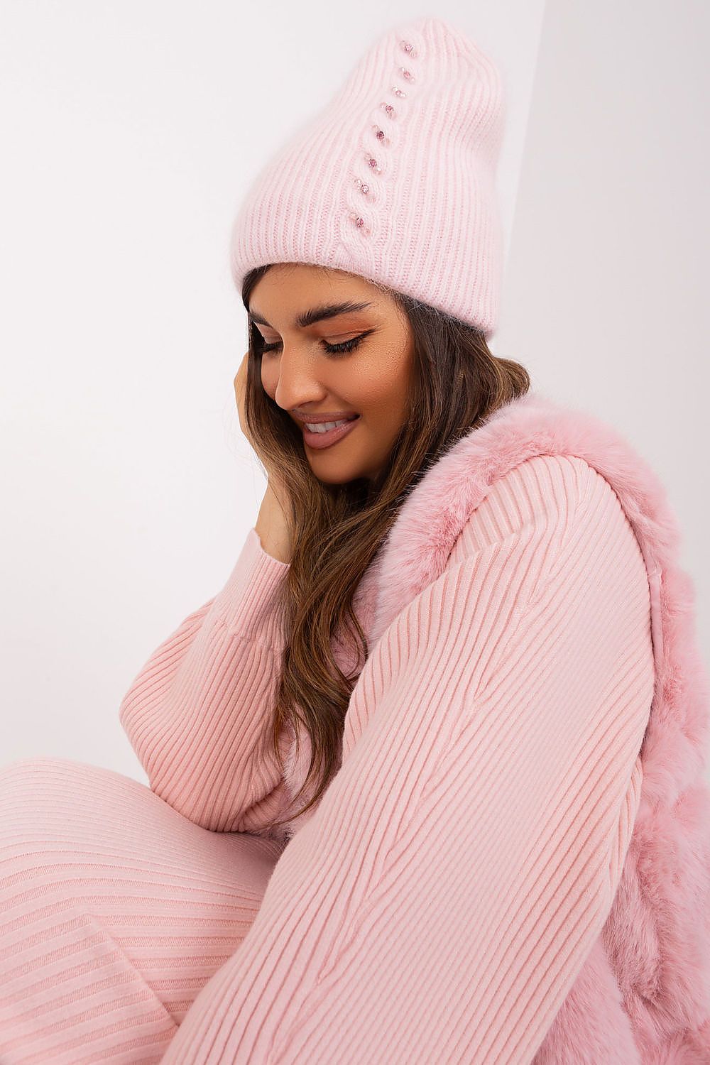 Luxurious warm winter hat from AT with braided design and unique front embellishment, made from 60% acrylic and 40% angora for ultimate warmth.