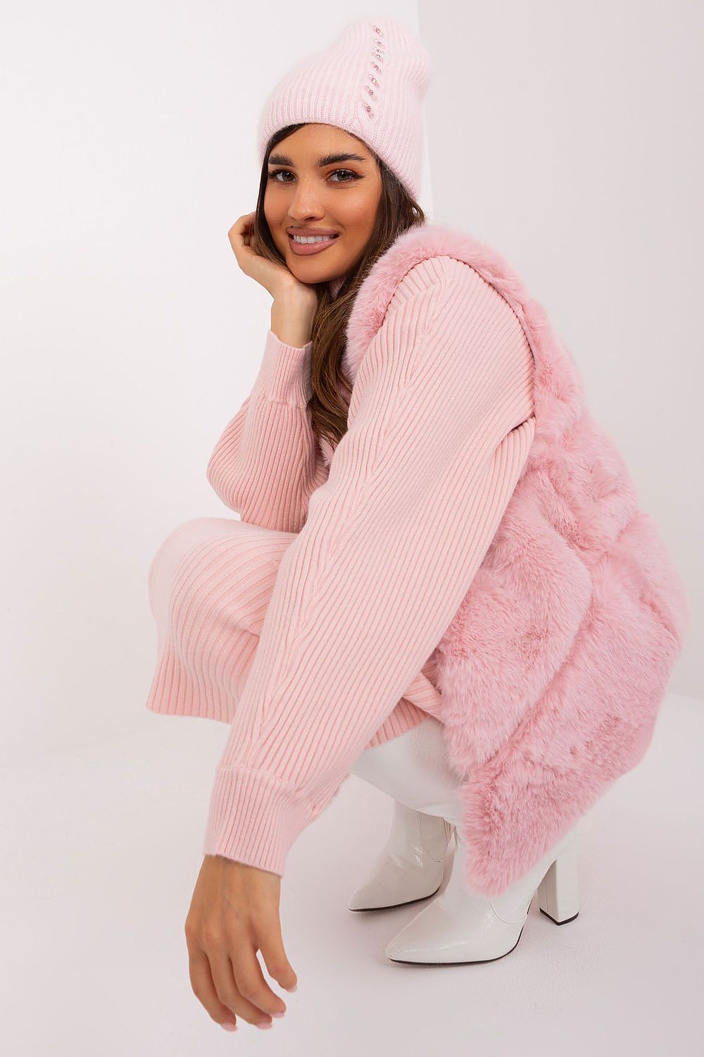 Fashionable winter hat offered by AT, elegantly designed with a braided motif and unique front detailing, composed of 60% acrylic and 40% angora for refined warmth.