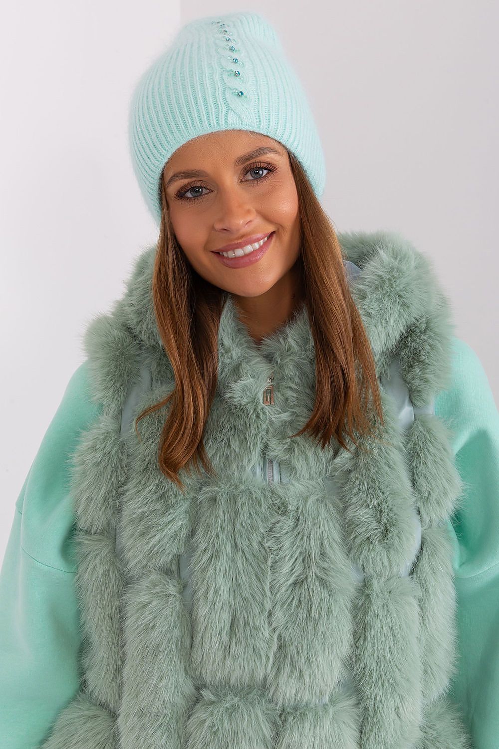 Elegant winter warm hat by AT featuring a sophisticated braided pattern and unique front application, made from 60% acrylic and 40% angora.