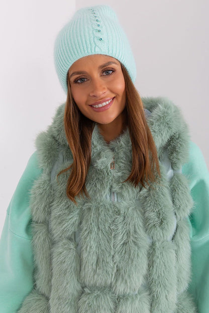 Elegant winter warm hat by AT featuring a sophisticated braided pattern and unique front application, made from 60% acrylic and 40% angora.