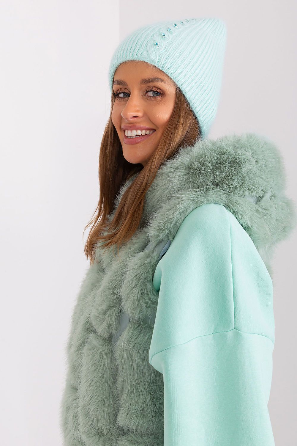 Stylish winter hat by AT with intricate braided design and exclusive decorative front, crafted from high-quality 60% acrylic and 40% angora.