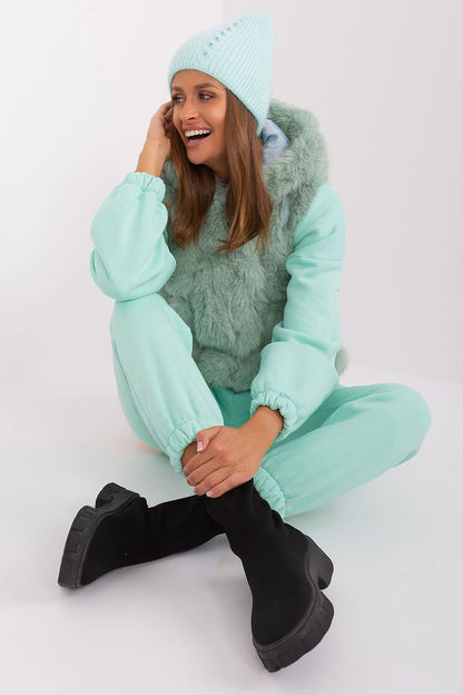 Chic winter warm hat by AT featuring an elegant braided pattern and a unique application on the front, composed of 60% acrylic and 40% angora.