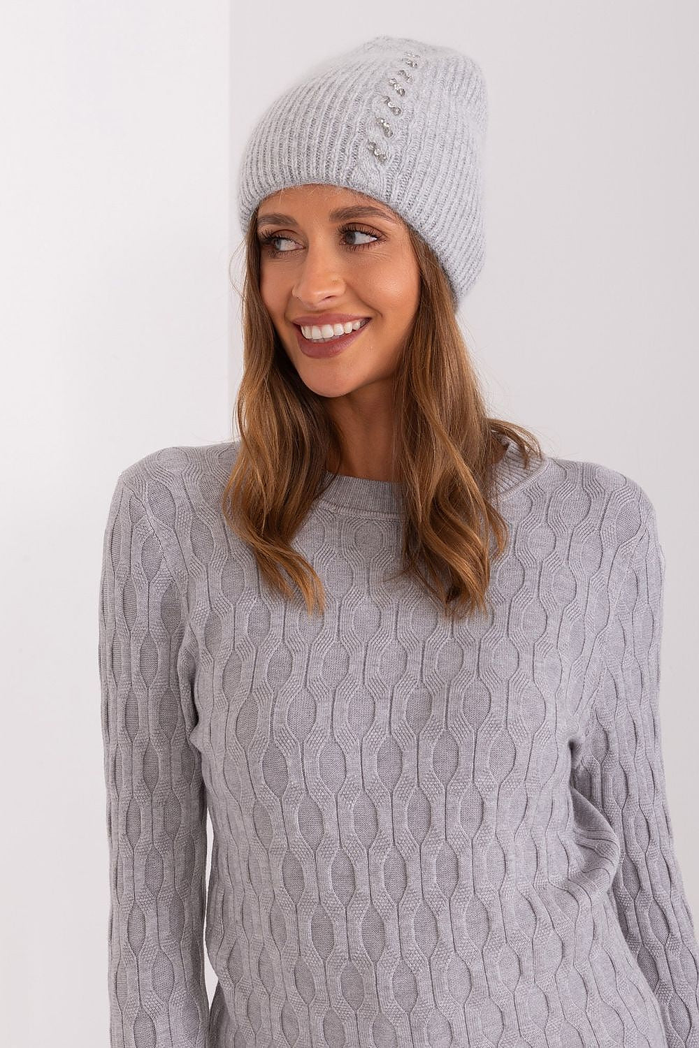 Fashionable winter hat by AT with a refined braided motif and eye-catching front detail, made from a blend of 60% acrylic and 40% angora.