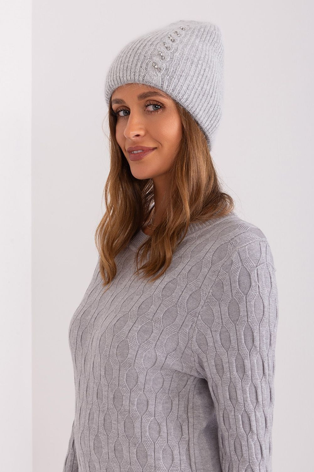Elegant winter warm hat by AT featuring a luxurious braided pattern and unique front application, made of 60% Acrylic and 40% Angora.