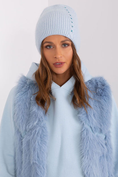 Refined winter hat from AT, with a distinctive front application and a blend of acrylic and angora for ultimate warmth.