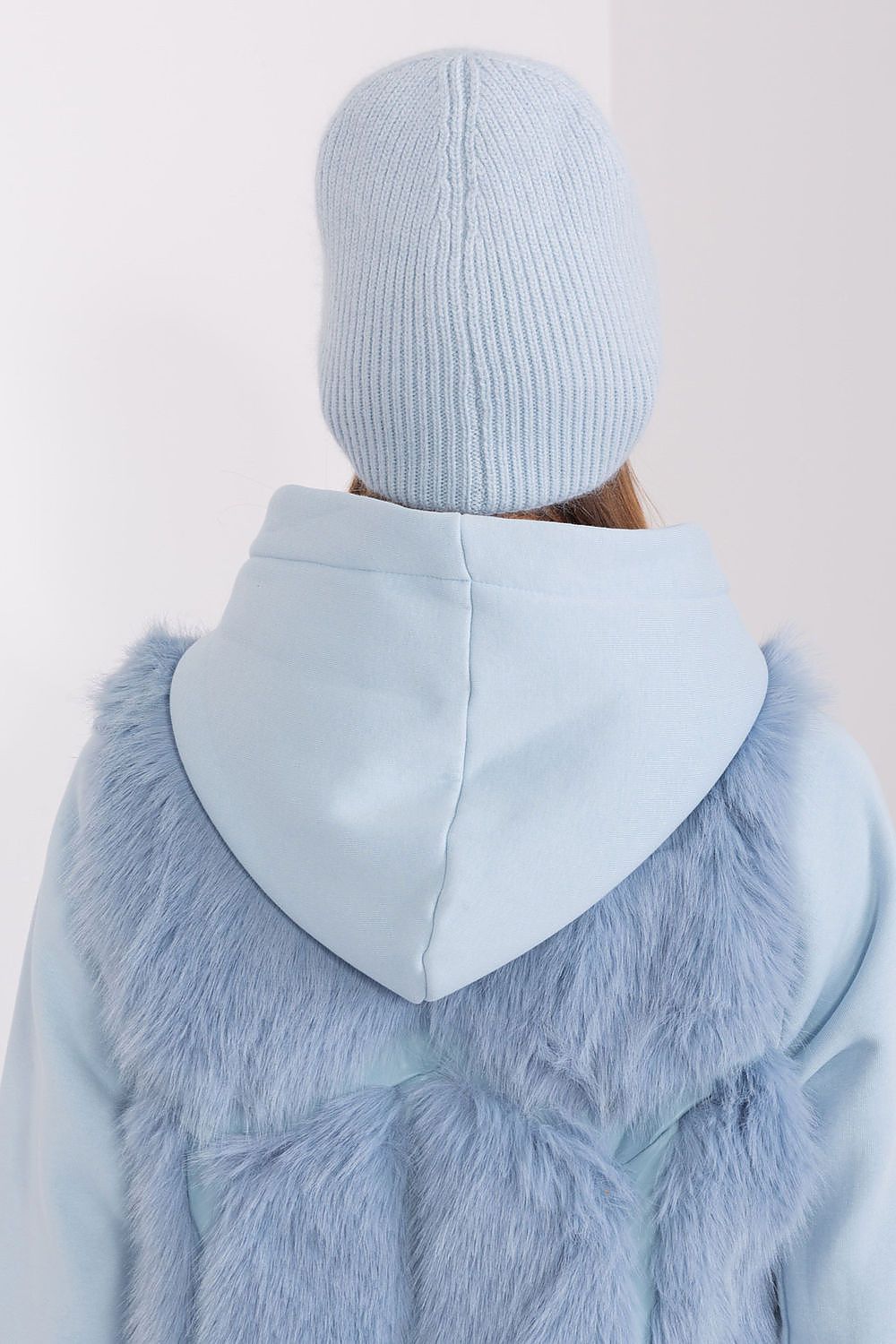 Side view of the sophisticated winter hat with a braided design and distinctive application, made by AT, perfect for stylish warmth in cold weather.