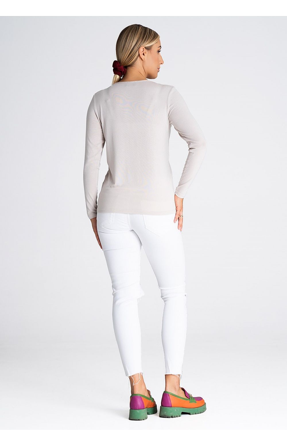Model wearing a luxury Figl blouse with long sleeves and V-neck, demonstrating its stylish appeal and comfortable fit for sophisticated outfits.