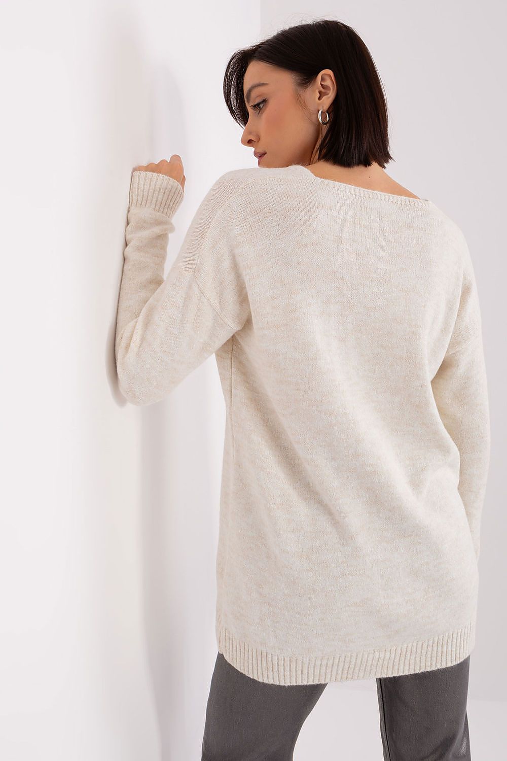 Model wearing the Rue Paris long sleeve acrylic jumper with heart neckline, highlighting its versatility for both casual and formal occasions.