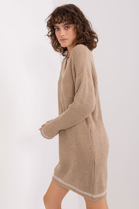 Detailed view of Badu oversized knit dress, showcasing the elegant heart neckline and long sleeves in a rich, warm fabric.