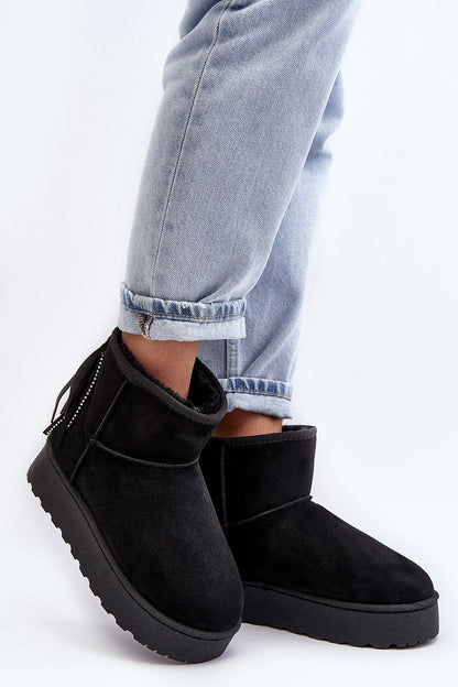 Elegant black eco-suede ankle snow boots with fur lining and tassel detail by Step in Style, paired with rolled-up jeans for a chic look.