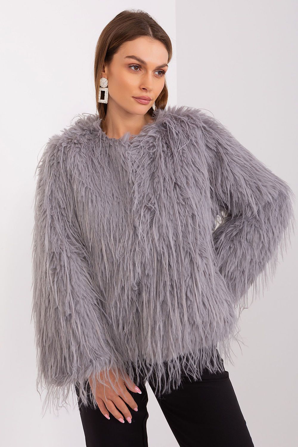 Glamorous transitional jacket with luxurious fur accents designed by AT, emphasising elegance and comfort for the modern woman.
