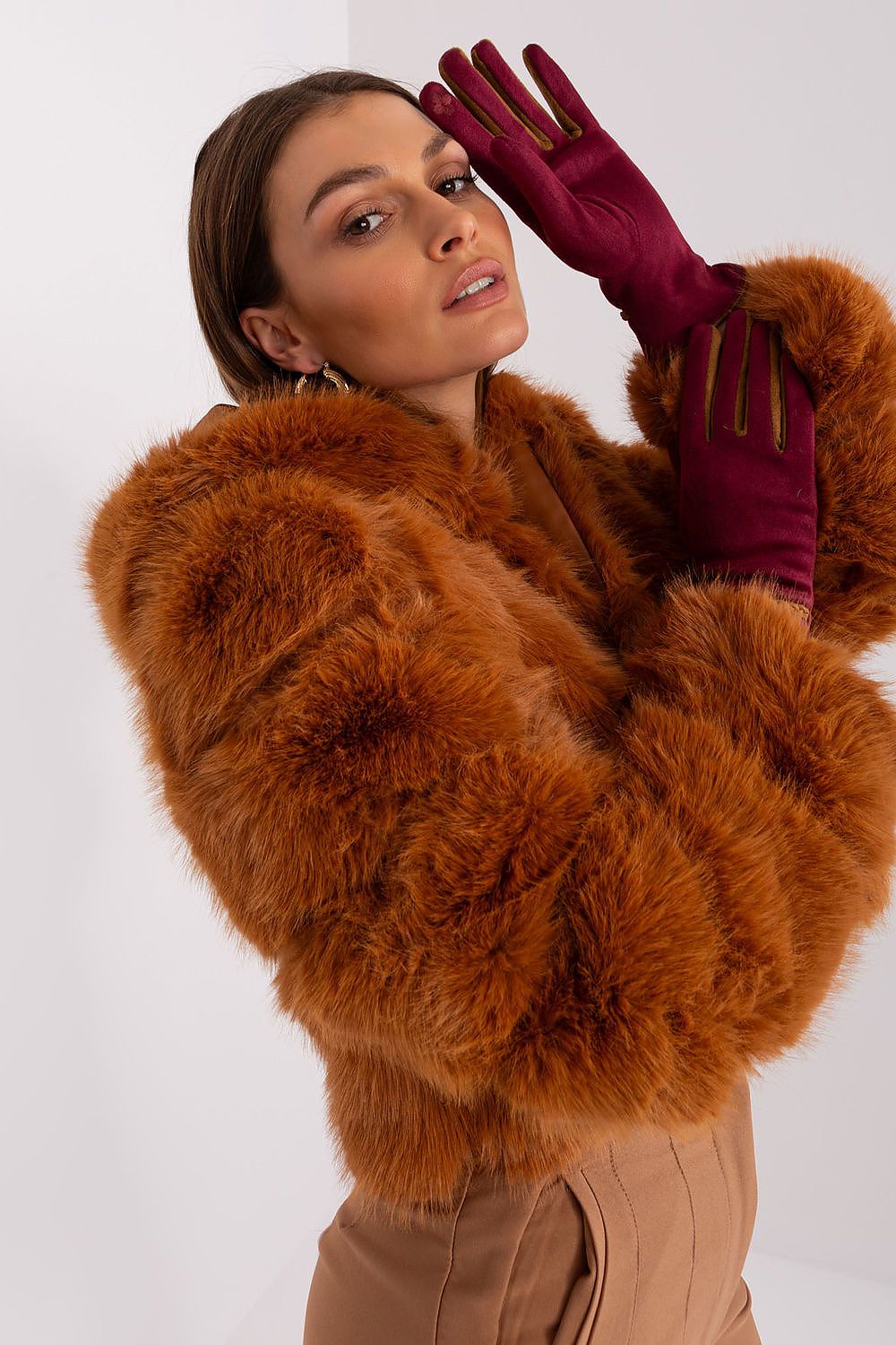 Stylish women's gloves by AT showcasing decorative braided straps and operated by touchscreen fingers.