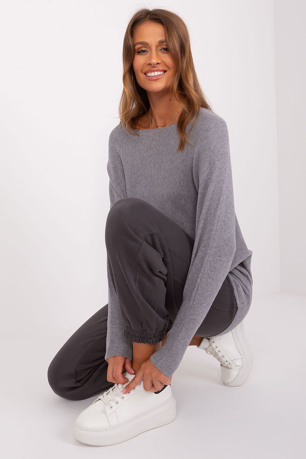 Elegant loose-cut batwing sweater showcasing round neckline and long sleeves, made by Factory Price for versatile styling.