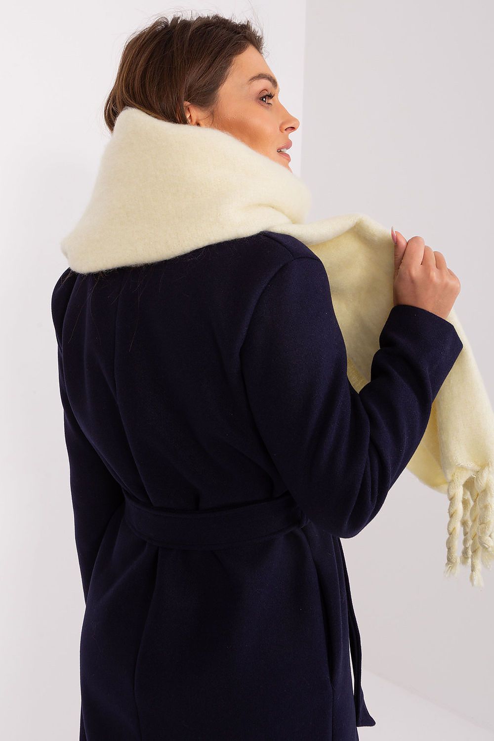Sophisticated warm shawl by AT, crafted from 100% polyester, showcasing a smooth texture and stylish tassels.