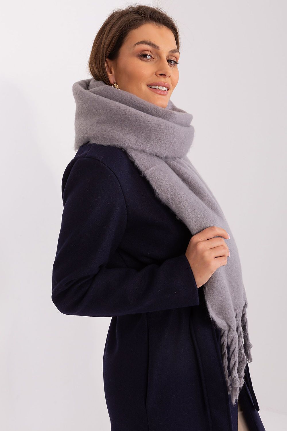 AT's stylish long scarf made from durable polyester, ideal for layering in colder months with delicate tassels.