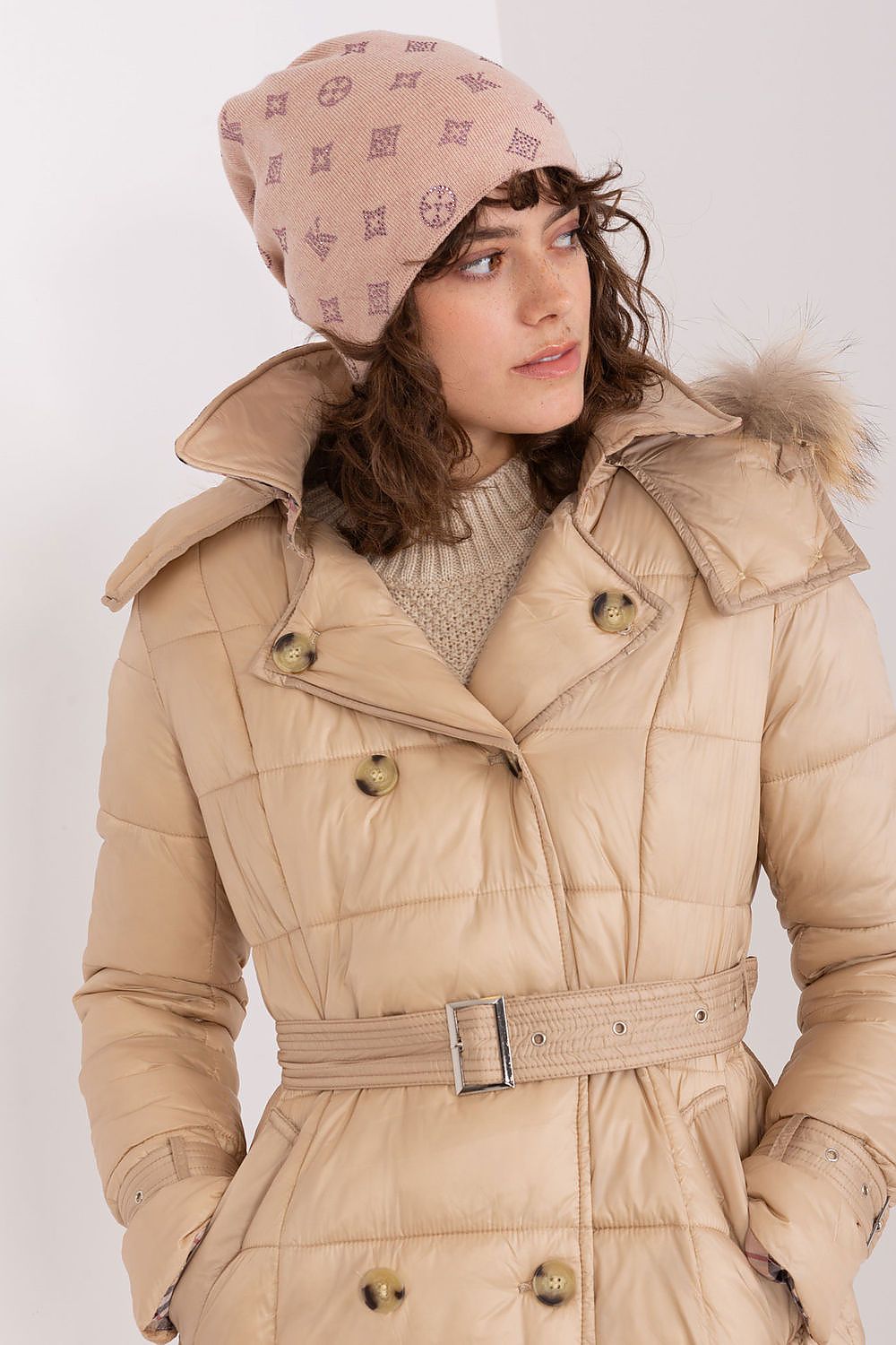 Stylish woman wearing AT luxurious winter beanie hat, blending warmth and elegance with cashmere and rhinestones.