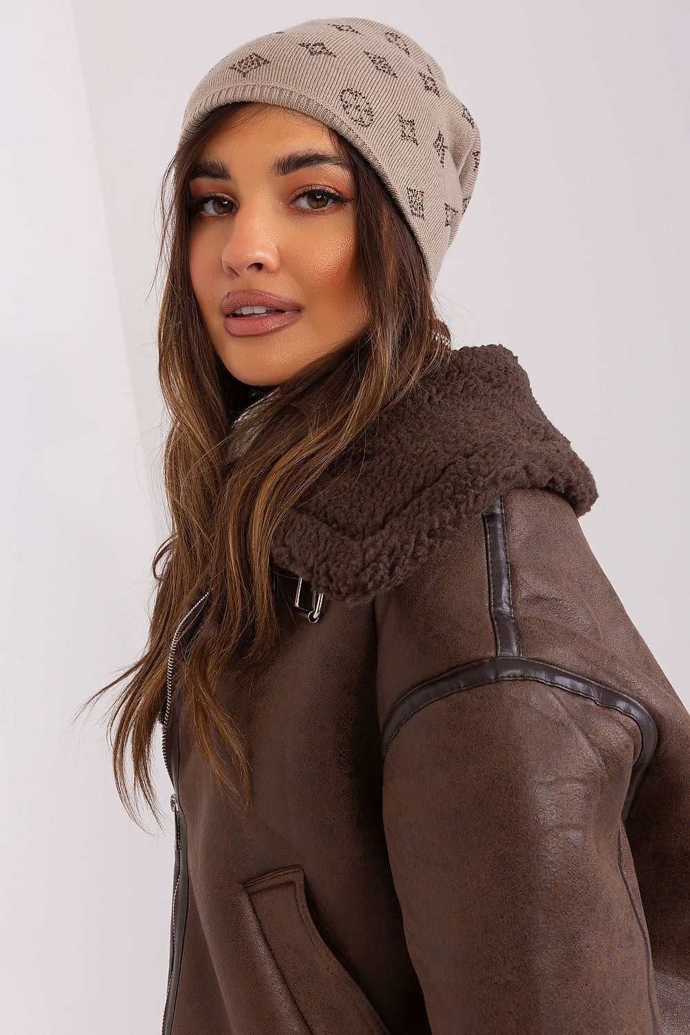 AT's women's cashmere blend beanie hat showcased against a snowy backdrop, exemplifying luxury and warmth for the winter season.