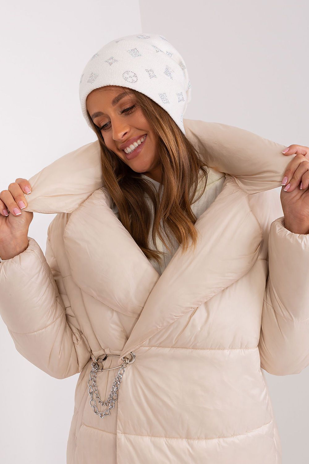 Stylish winter beanie featuring a warm cashmere blend and shimmering rhinestone details, designed by AT.