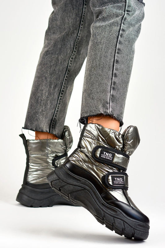 Close-up view of PRIMO's luxurious silver snow boots for women, showcasing the eco fur lining and refined black accents, perfect for cold weather style.