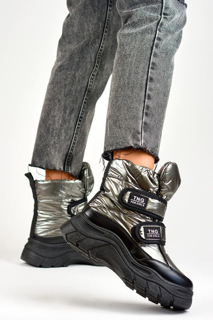 Close-up view of PRIMO's luxurious silver snow boots for women, showcasing the eco fur lining and refined black accents, perfect for cold weather style.