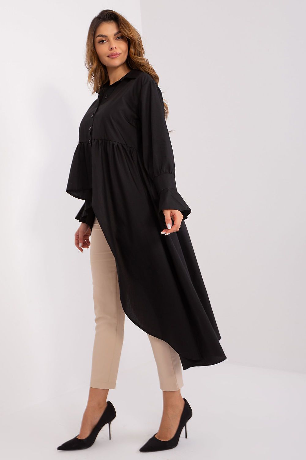 Asymmetrical hem of the Lakerta long sleeve shirt displayed on a hanger, highlighting its unique silhouette and luxurious appeal.