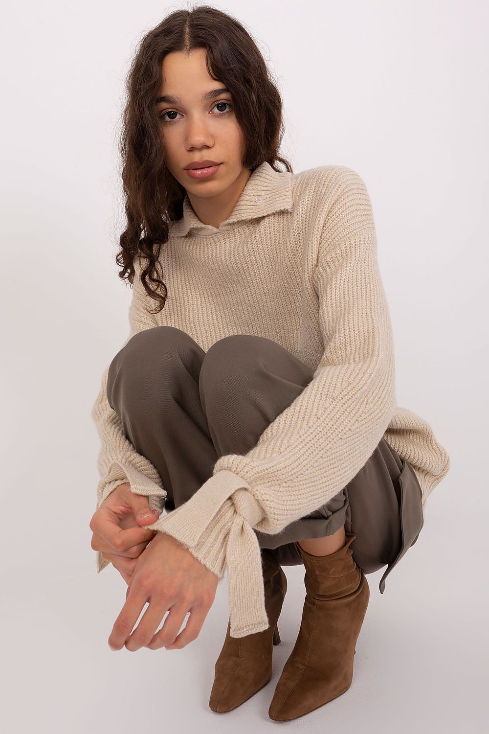 Model displaying the sophisticated Badu Jumper with a turtleneck style, ideal for formal occasions.