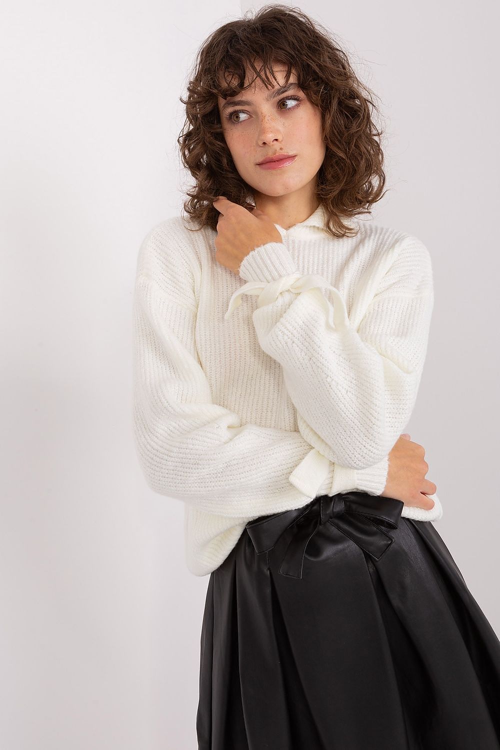 Elegant Badu Jumper in luxurious turtleneck style, showcasing decorative cuffs for a sophisticated look.