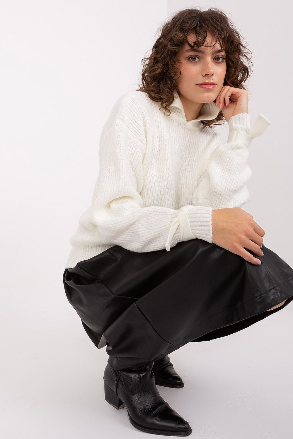 Side view of the elegant Badu Jumper featuring a turtleneck design and stylish decorative cuffs.